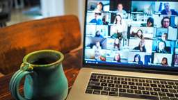 Image of screen zoom meeting and coffee cup