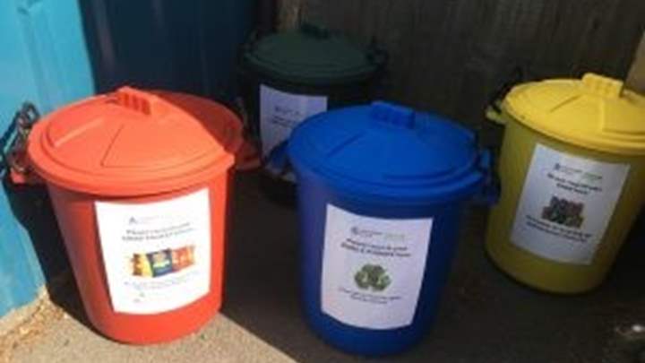 Coloured collection bins for recycled items at Lord Scudamore Primary School