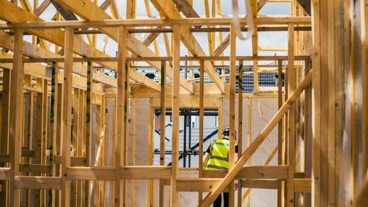 Worker at Taylor Lane building timber frame construction