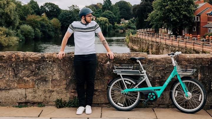 Man standing by the Old Bridge in Hereford with a Beryl electric bike