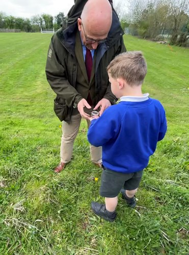 School kid showing something to the member of the staff