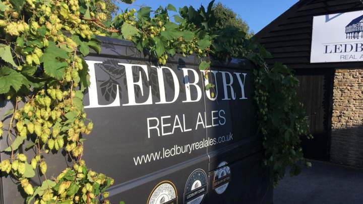 Van draped in hops with graphic text on the side which reads Ledbury Real Ales
