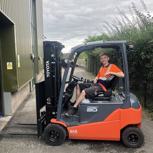 Wye Valley Brewery staff on a fork lifter looking at the camera smiling